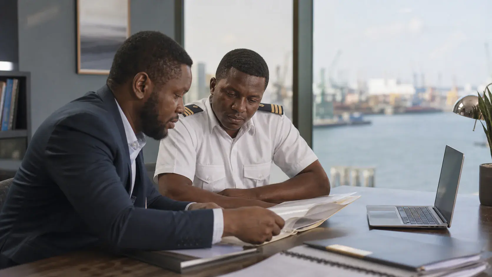 Consultant and seafarer working through an organised maritime document file